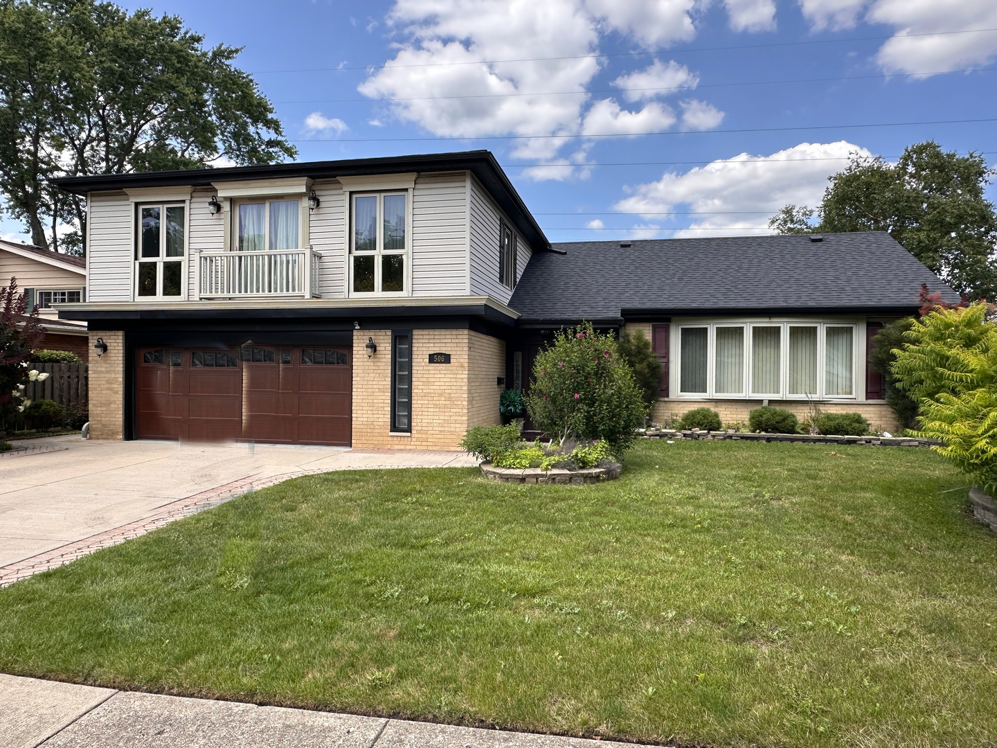 a front view of a house with a yard outdoor seating and garage