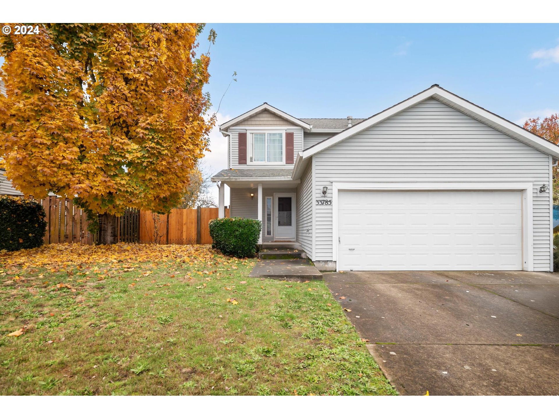 a view of a house with a yard and garage