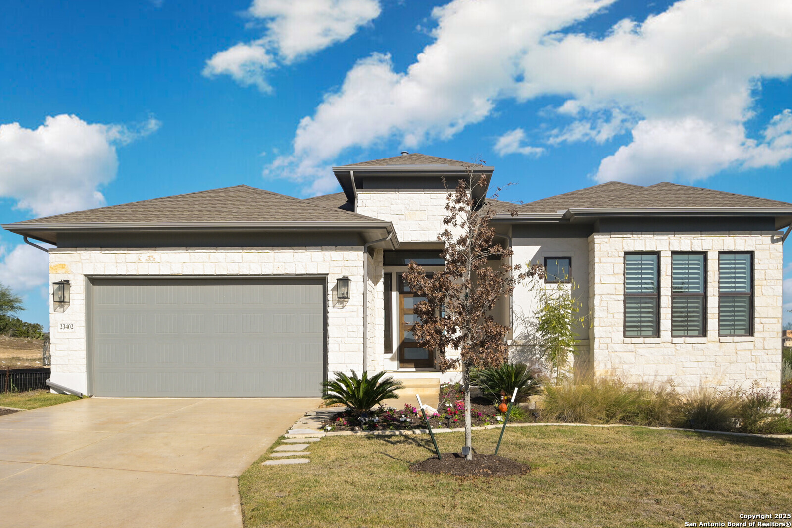 a front view of a house with garden