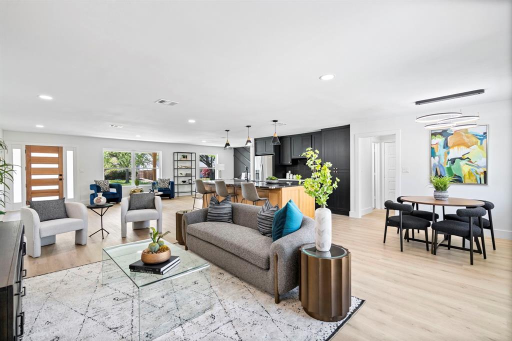 a living room with furniture a dining table and wooden floor