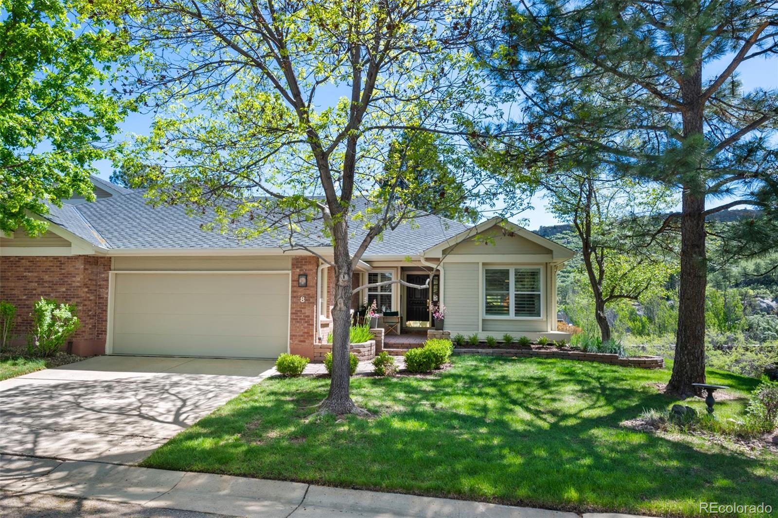 a front view of house with yard and green space