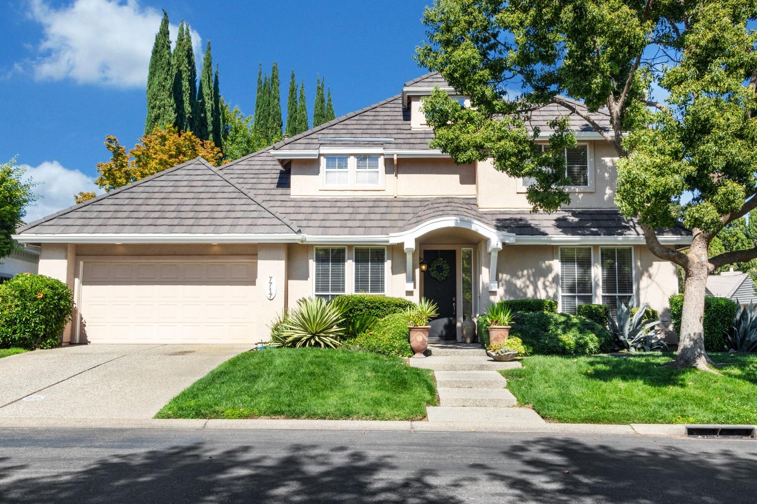 a front view of a house with a garden