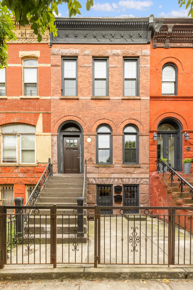 a view of a brick house with large windows