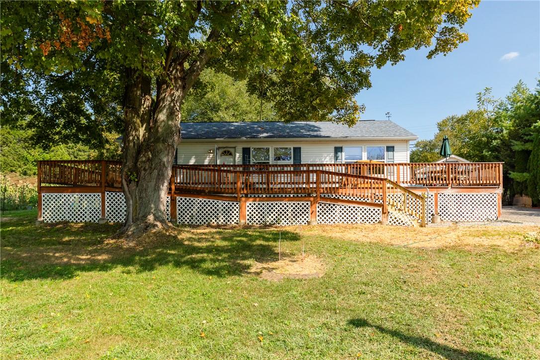 Rear view of property with a yard and a deck