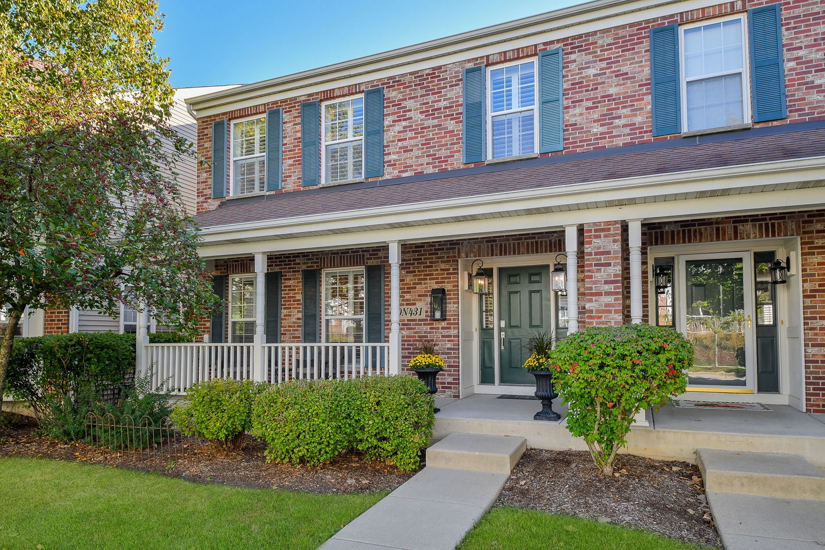 front view of a brick house with a yard