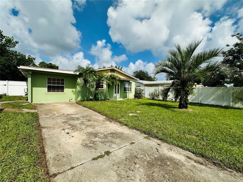 a front view of house with yard and green space