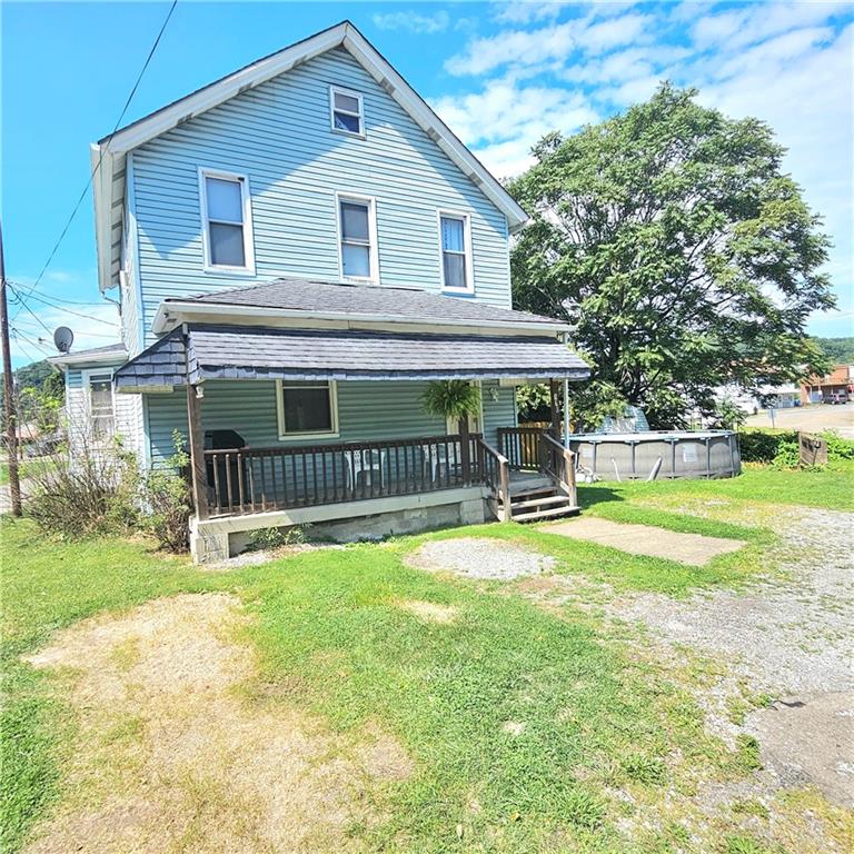 a view of a house with a yard and sitting area