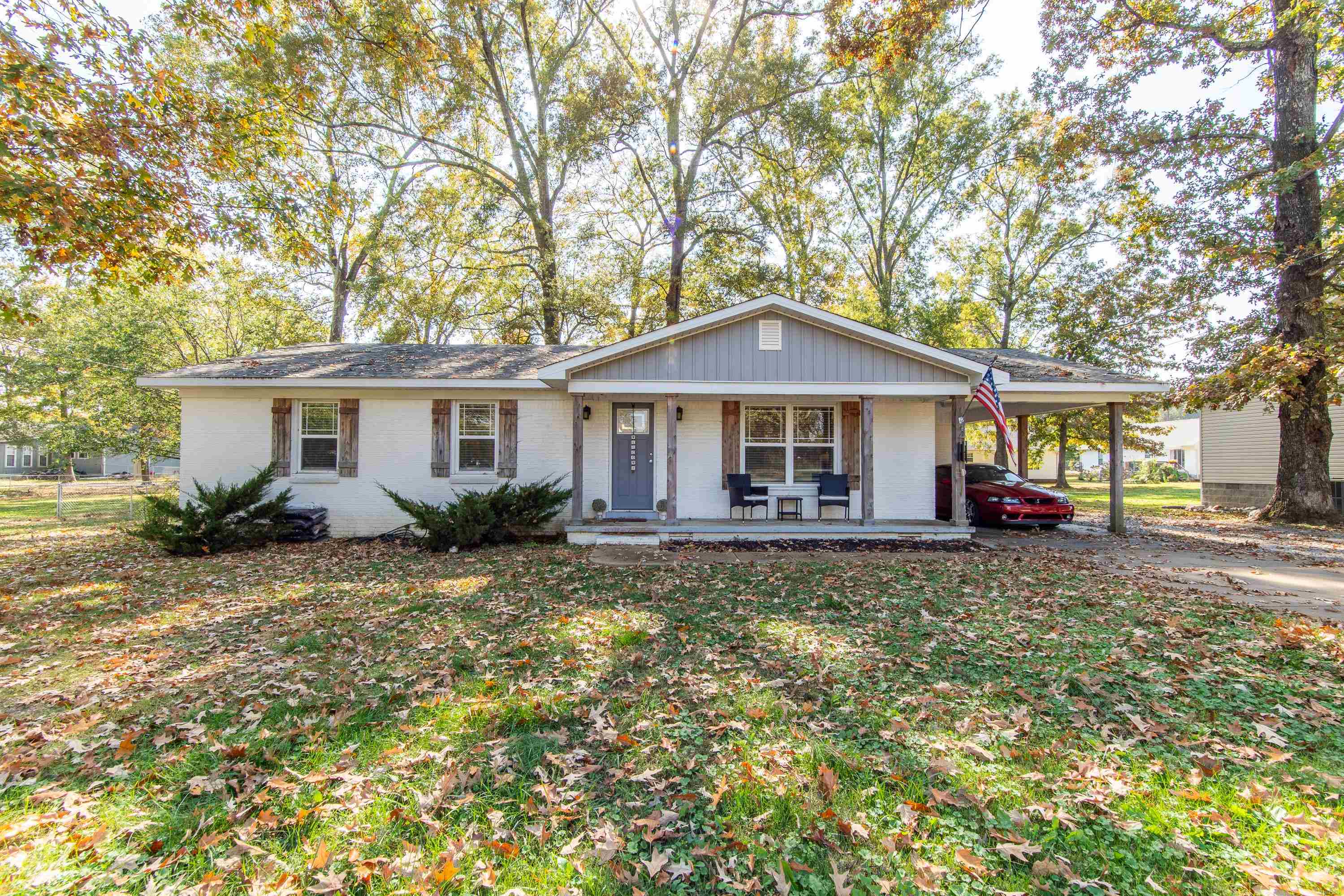 a front view of a house with yard porch and furniture