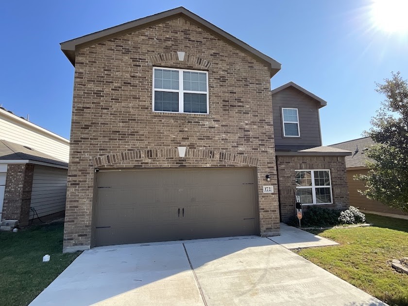 a front view of a house with yard