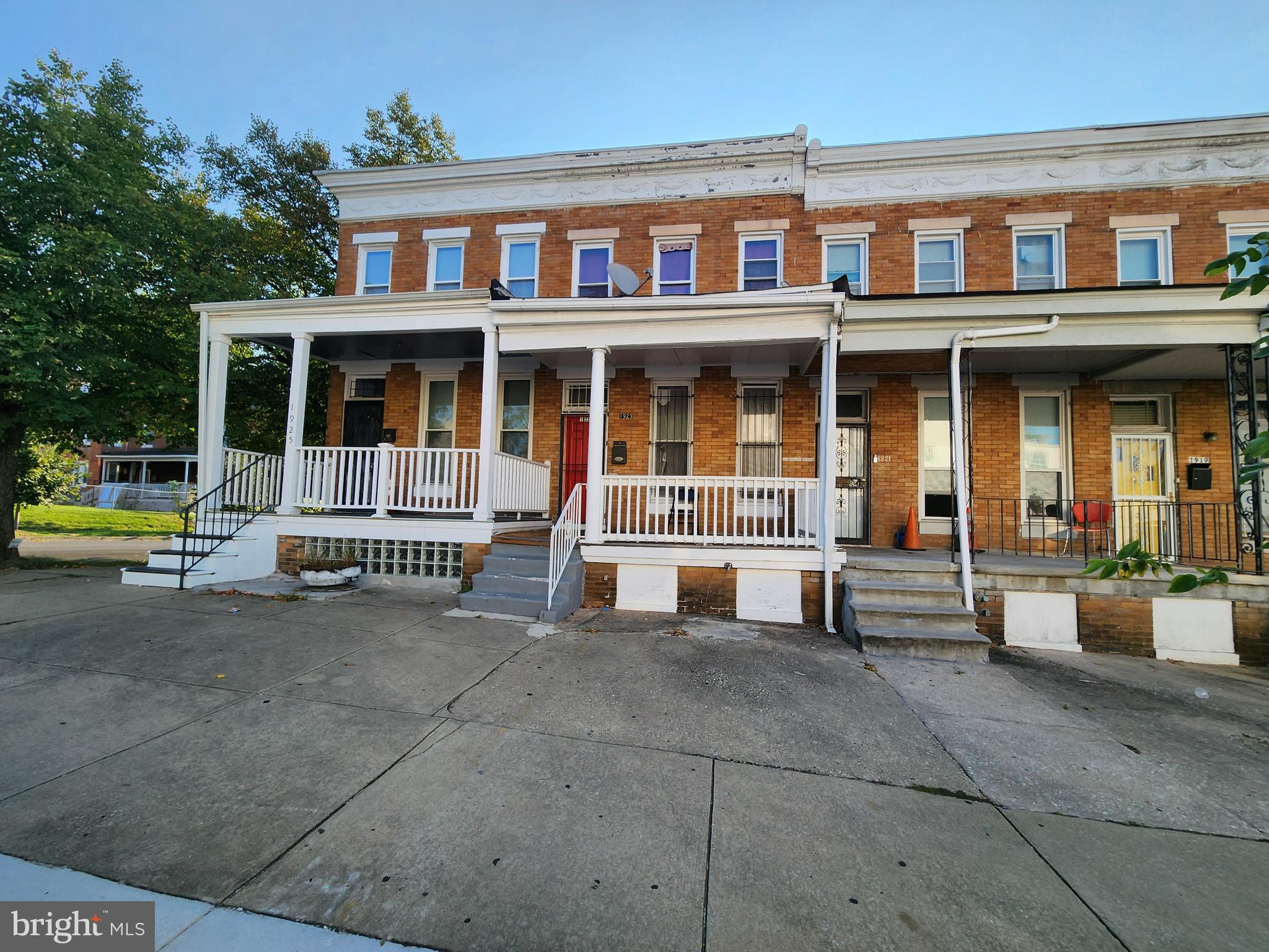 a view of a building with a bench next to a road