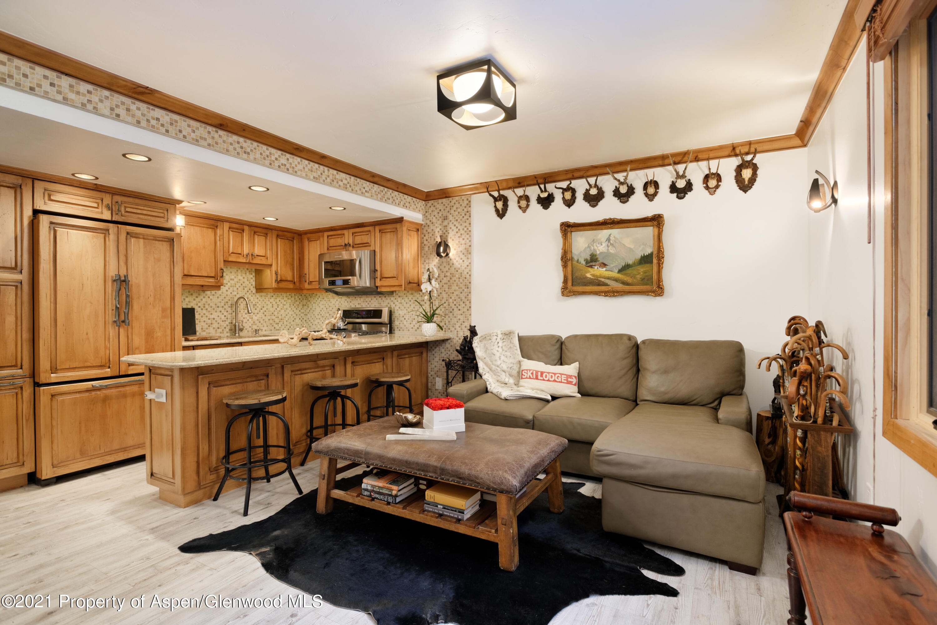 a living room with furniture and a kitchen view