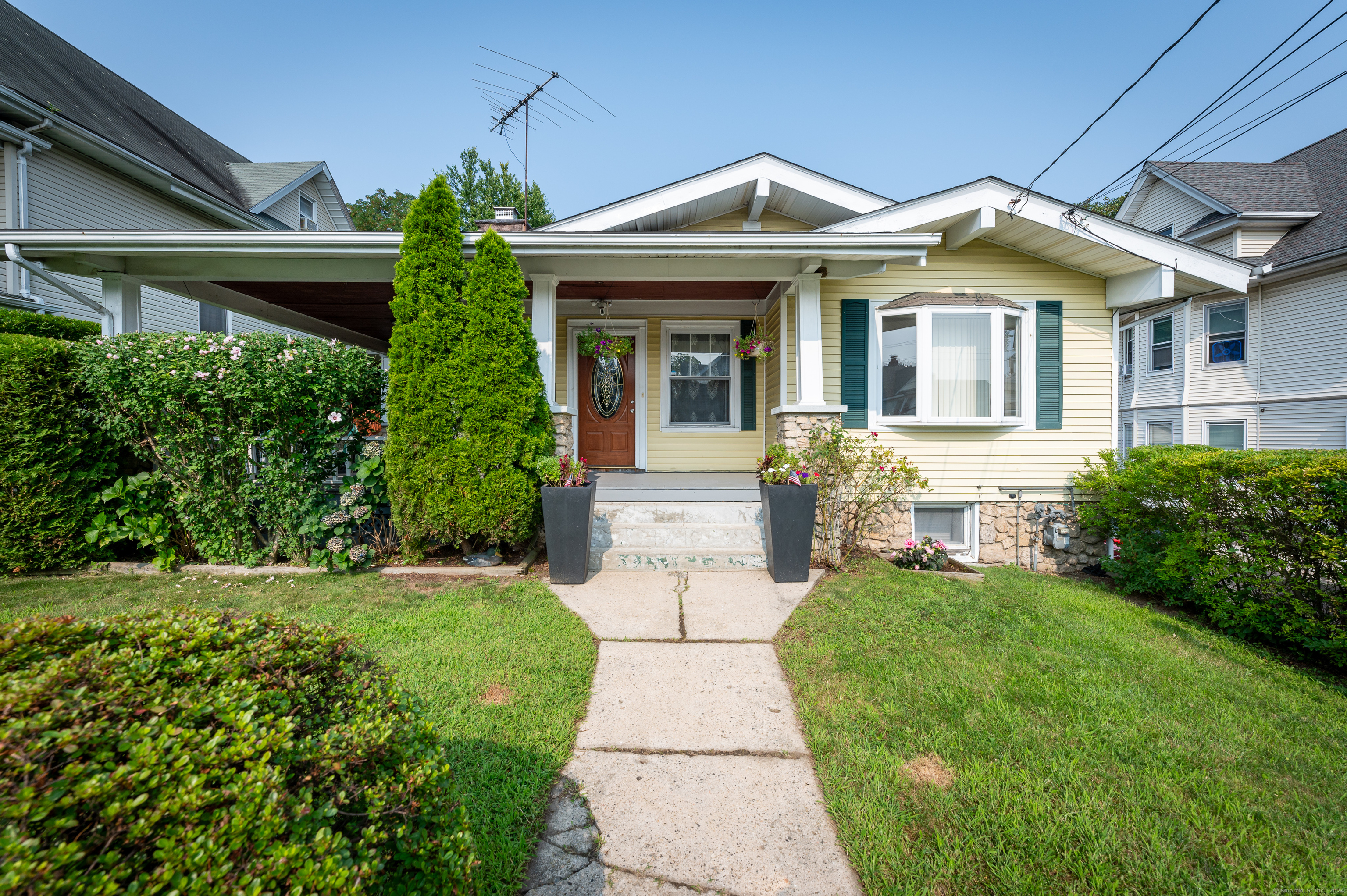 a front view of a house with a garden