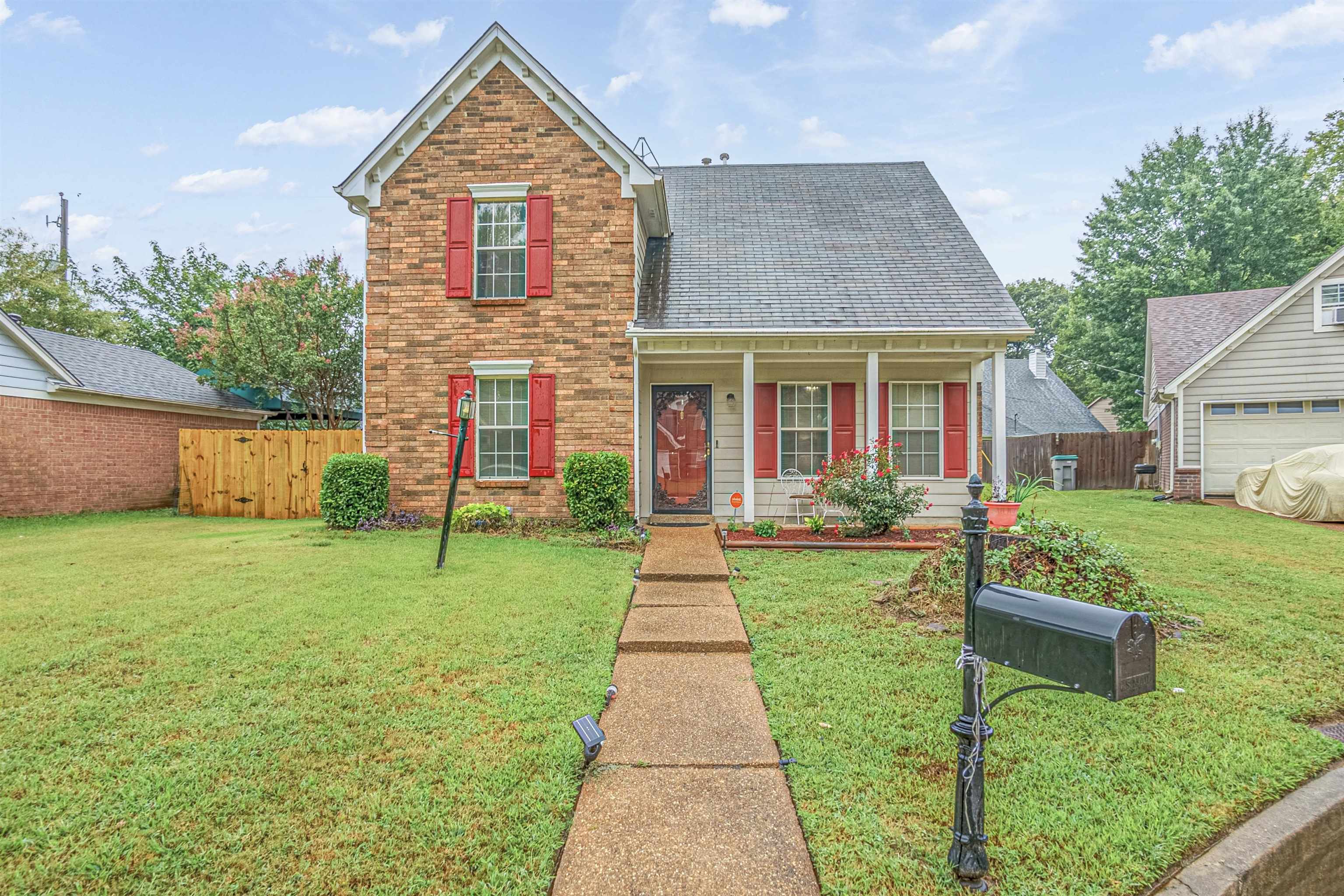 Front of property with a front yard and a garage