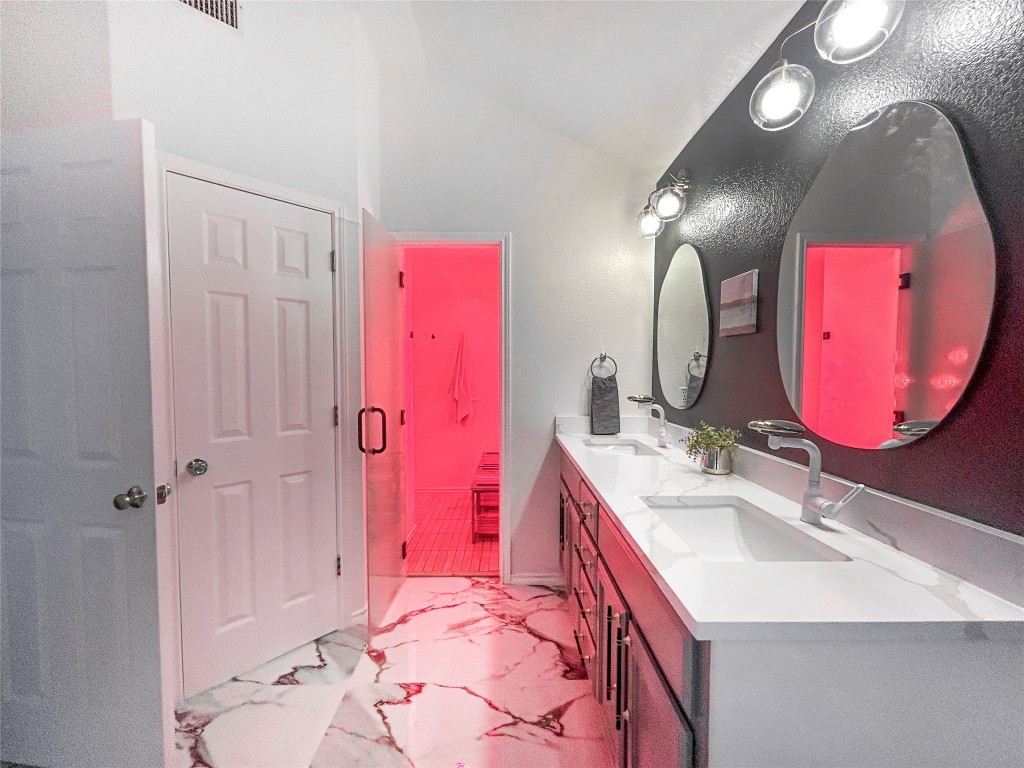 a bathroom with a sink vanity tub and shower