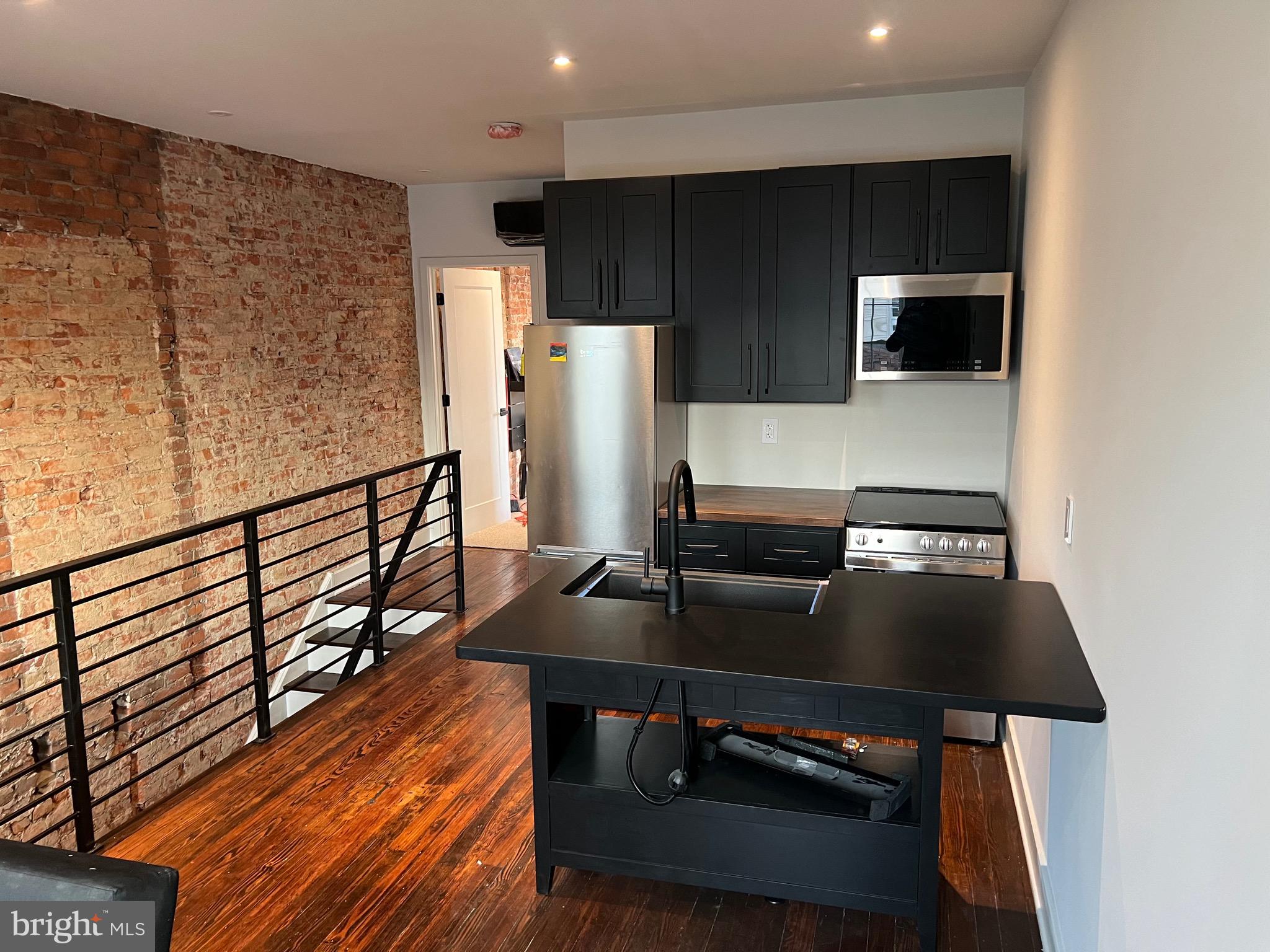 a kitchen with stainless steel appliances a refrigerator and a microwave