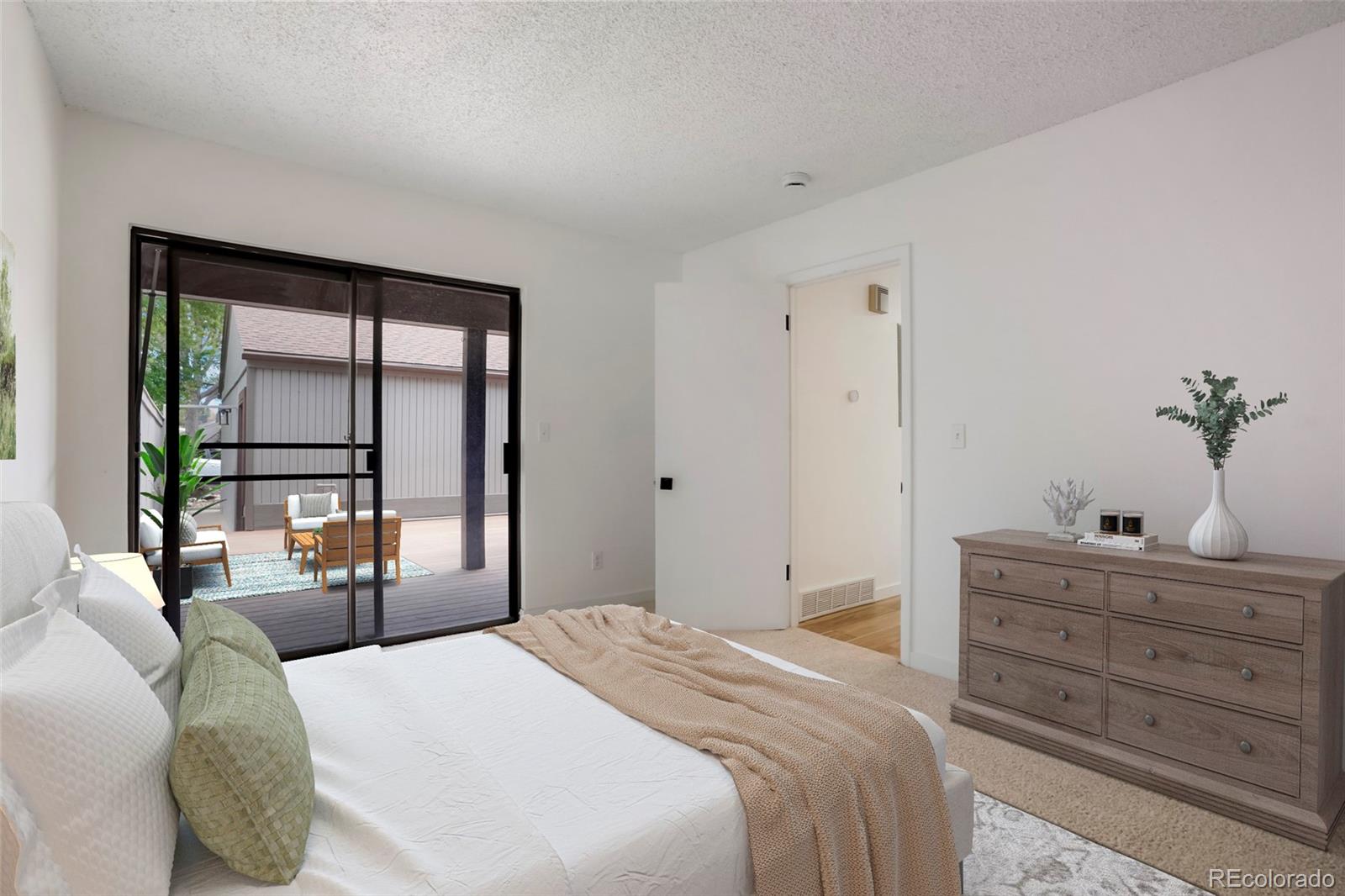 a bedroom with a bed and a potted plant