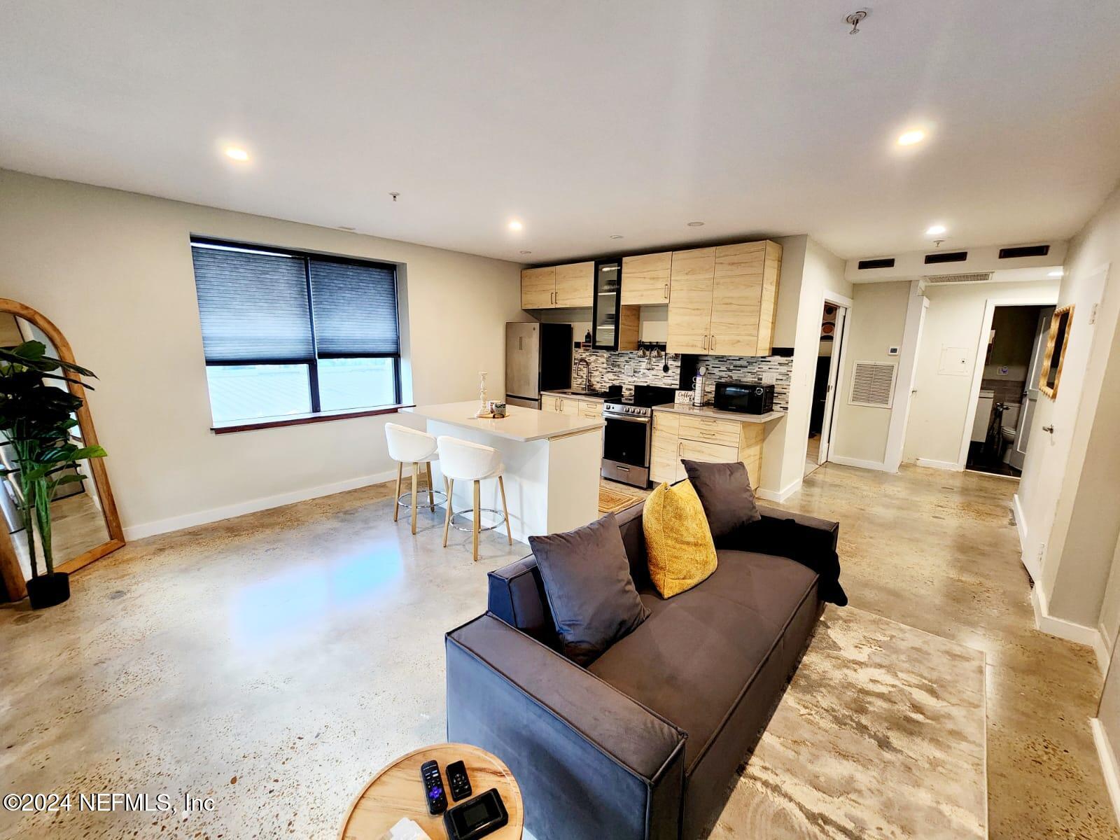 a living room with furniture and a potted plant