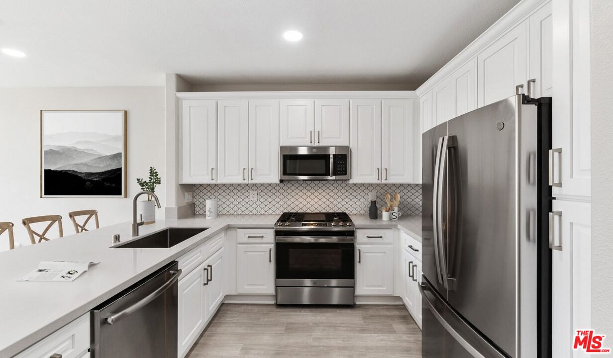 a kitchen with a refrigerator sink and stove