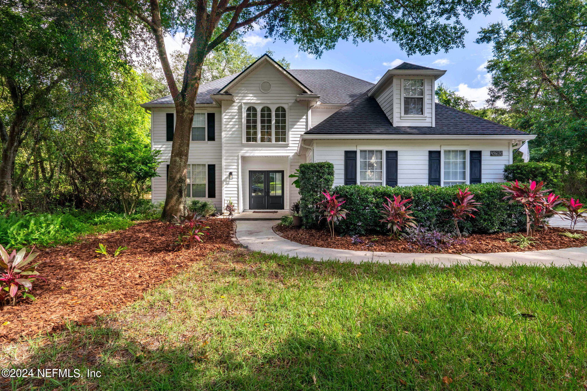 a front view of a house with a yard and porch