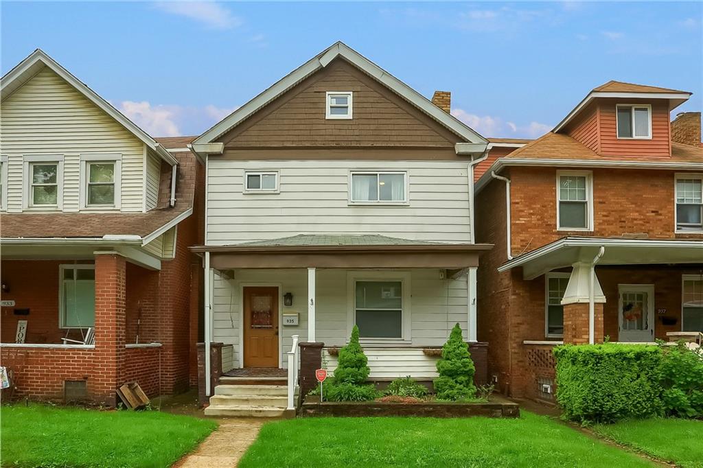 a front view of a house with a yard