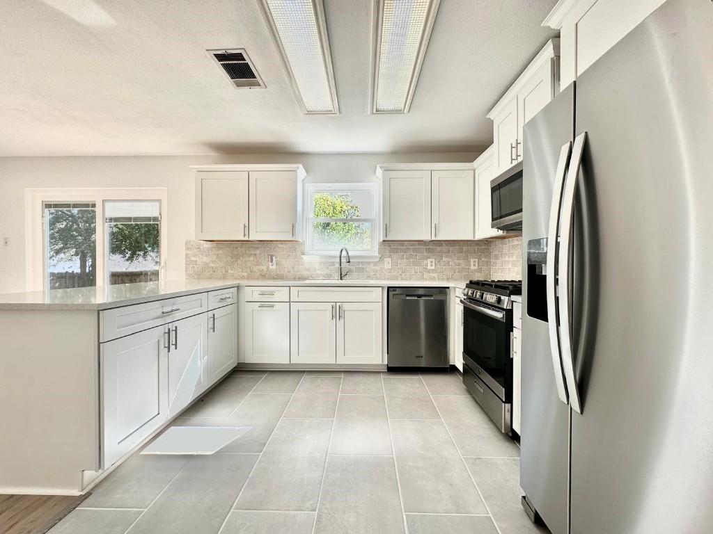 a kitchen with a refrigerator sink and window