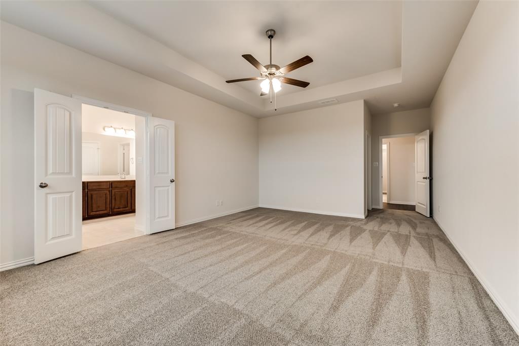 an empty room with a ceiling fan and a window