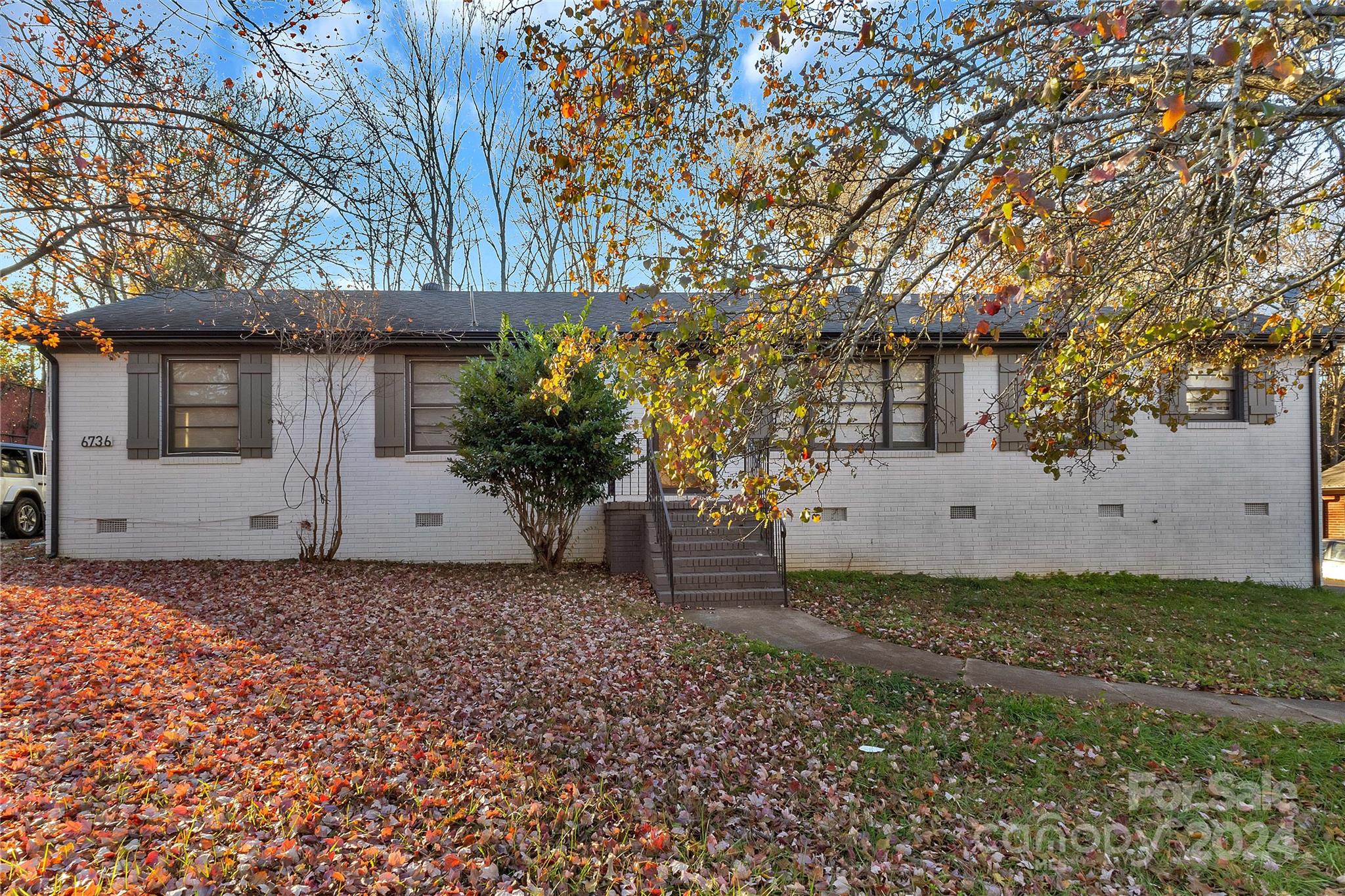 a view of a house with a tree