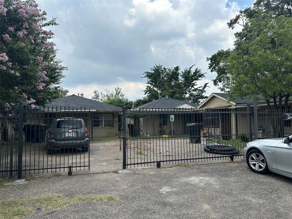 a view of a house with a cars parked