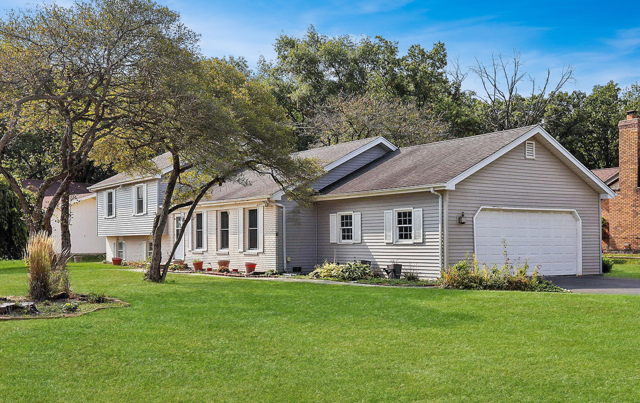 a front view of house with yard and green space