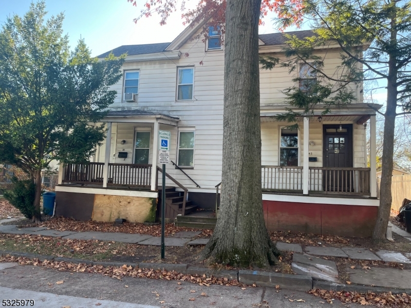 a view of a house with a yard and sitting area