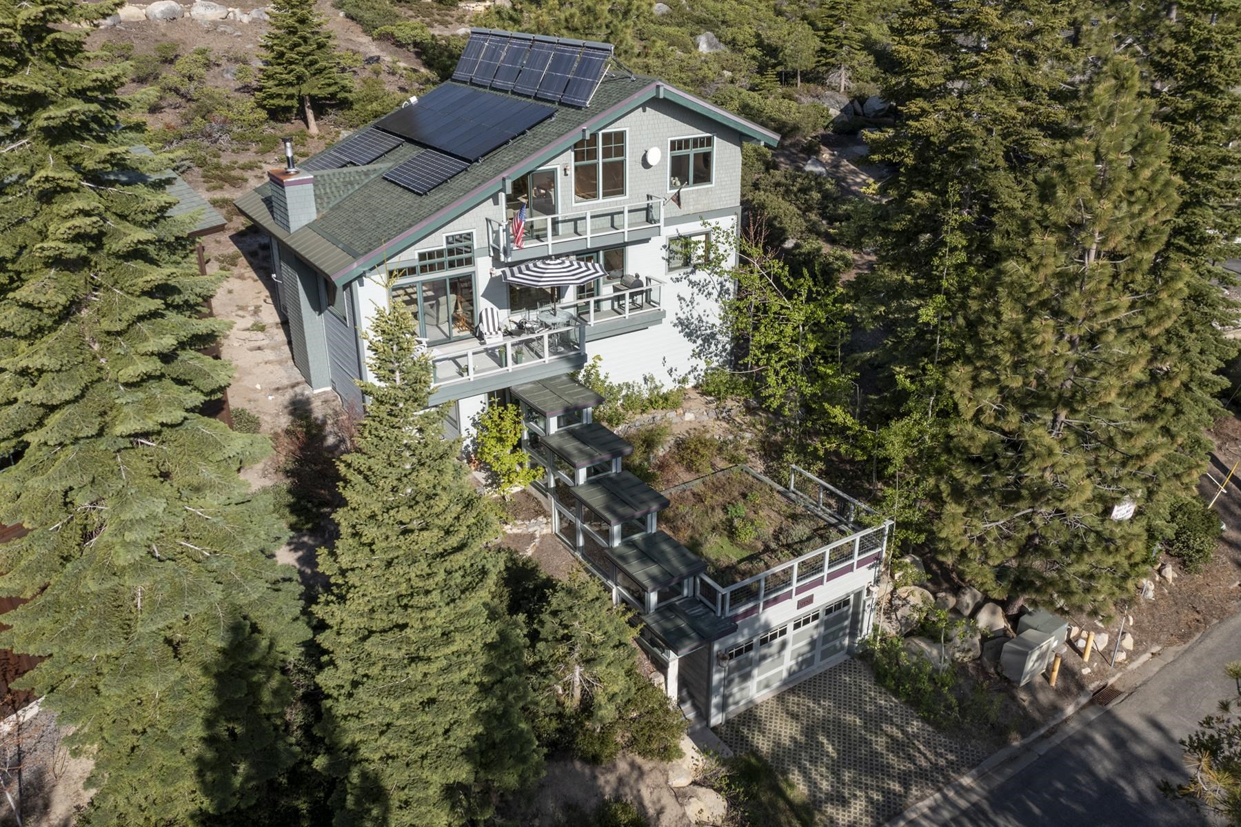 a aerial view of a house with a yard and potted plants