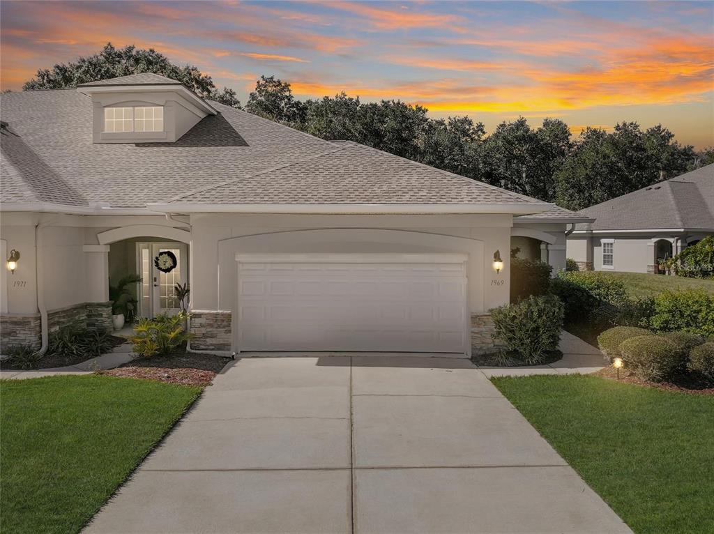 a front view of a house with a yard and garage