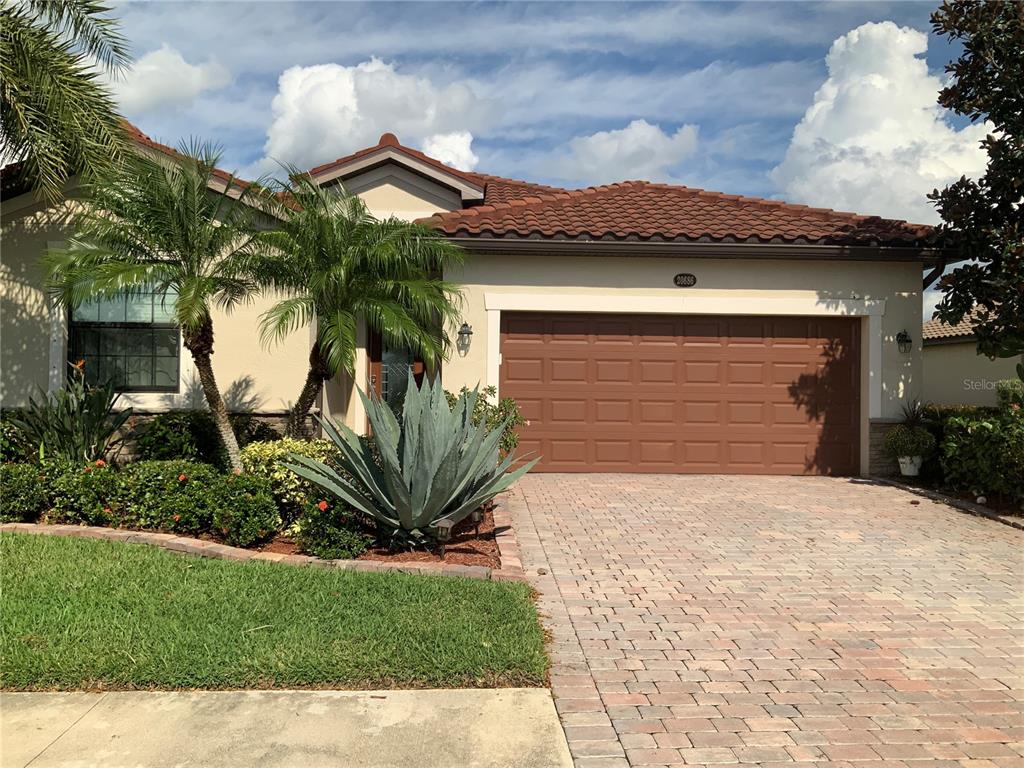 a front view of a house with a yard and garage