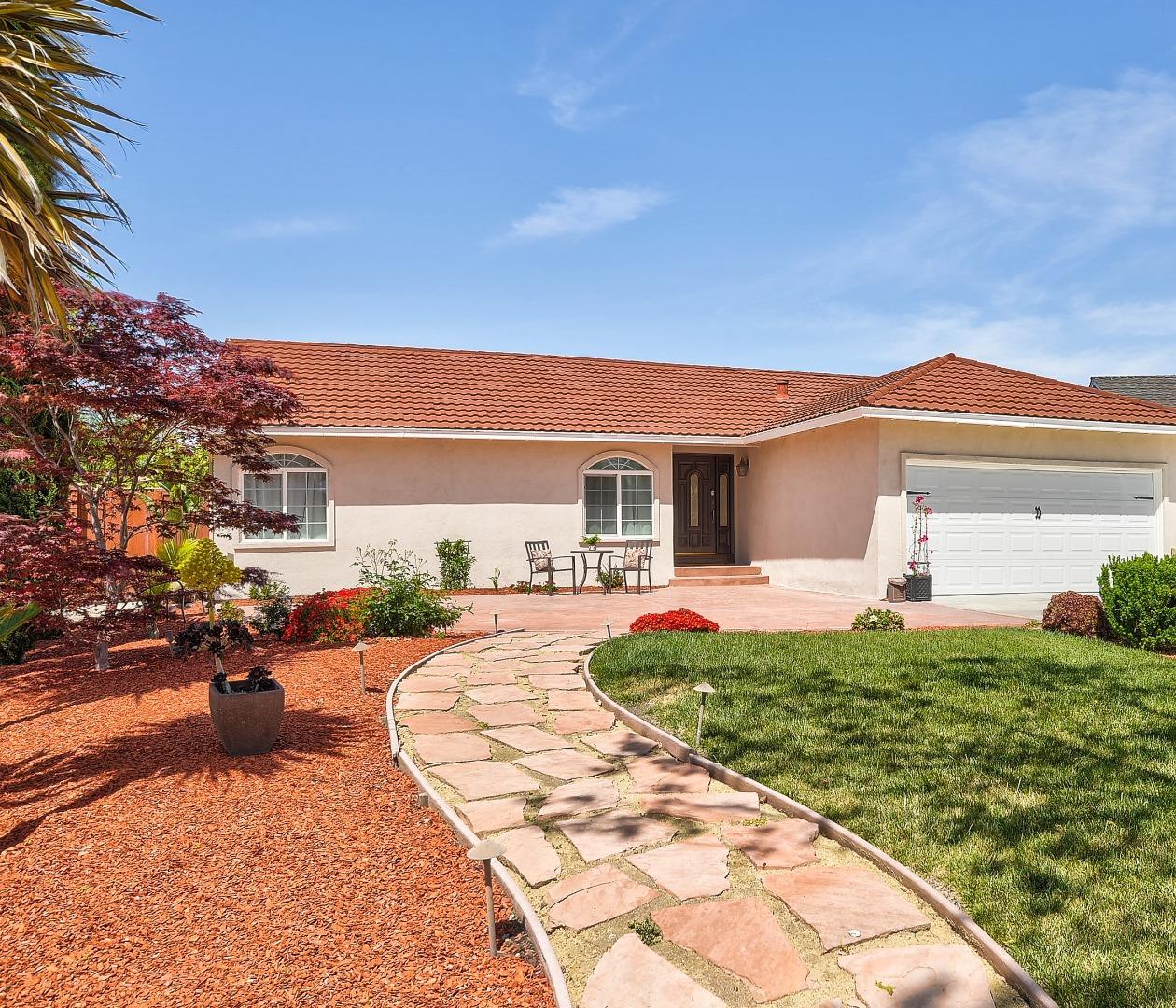 a front view of a house with a garden and patio