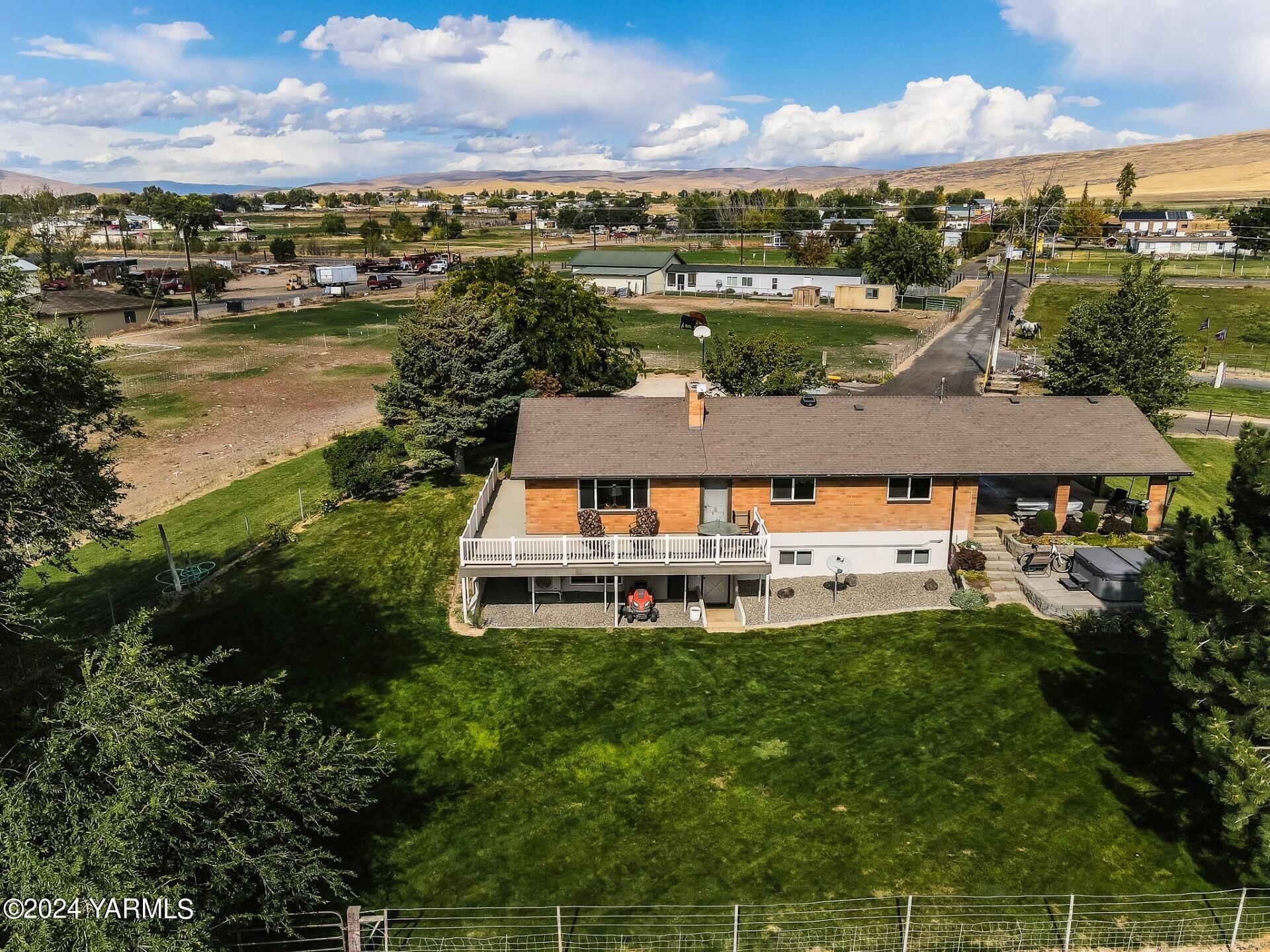 an aerial view of a house with a garden and lake view