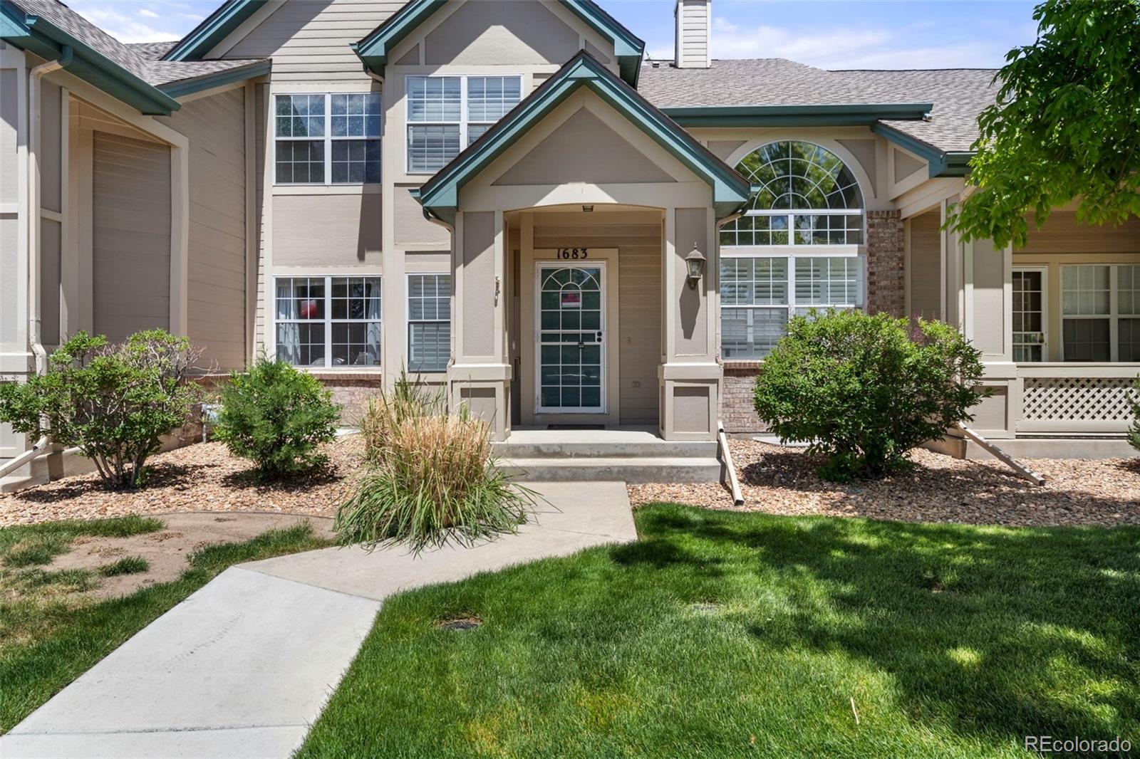 a front view of house and yard with green space