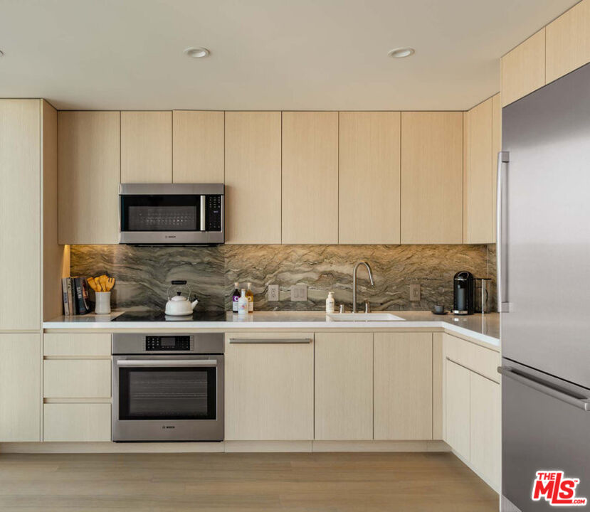 a kitchen with a sink stove and microwave