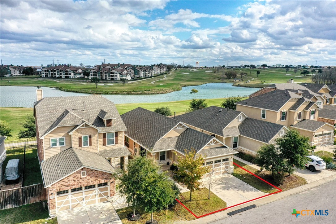 an aerial view of a house with big yard and lake view