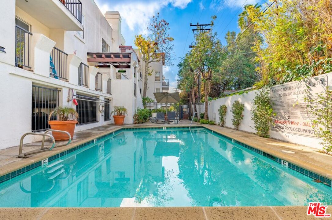 a swimming pool with outdoor seating and yard