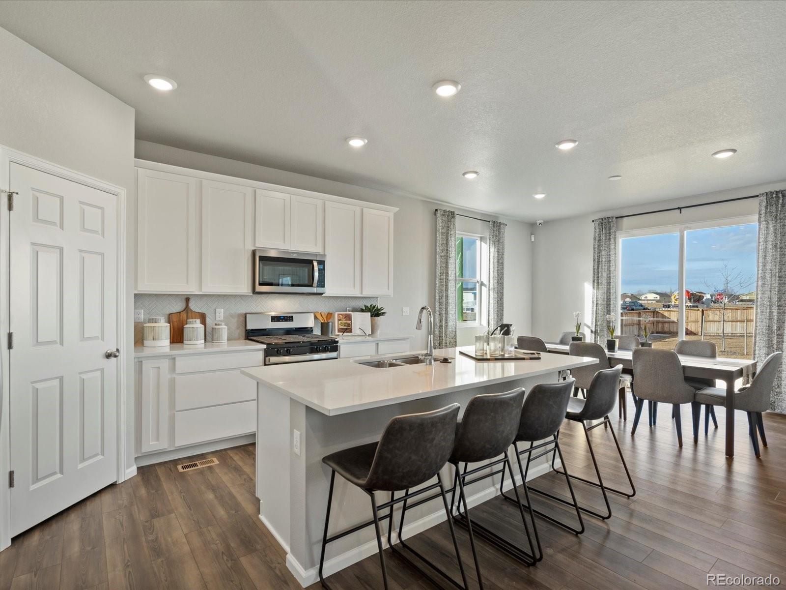 a kitchen with a table chairs stove and cabinets