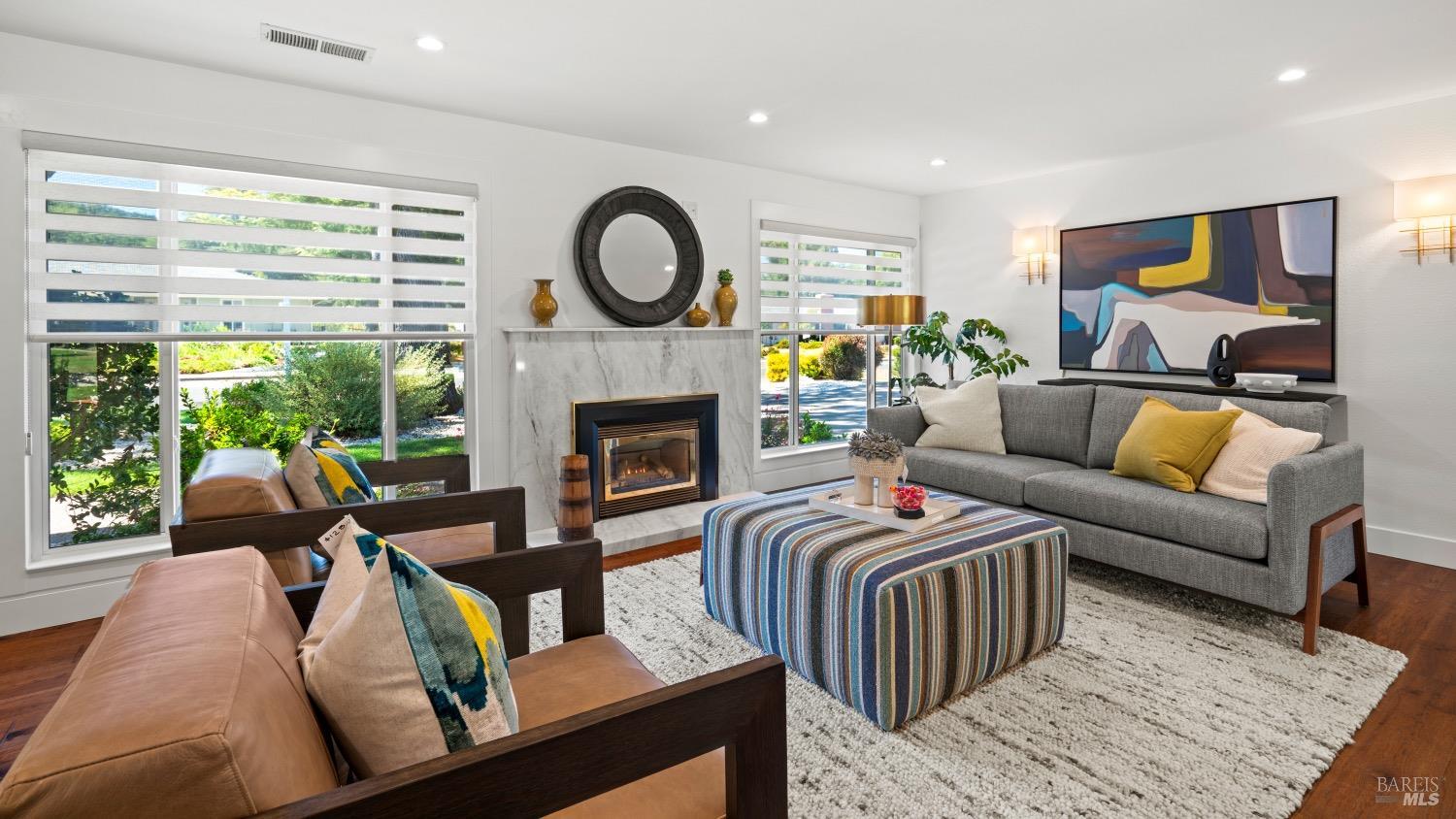 a living room with furniture and a fireplace