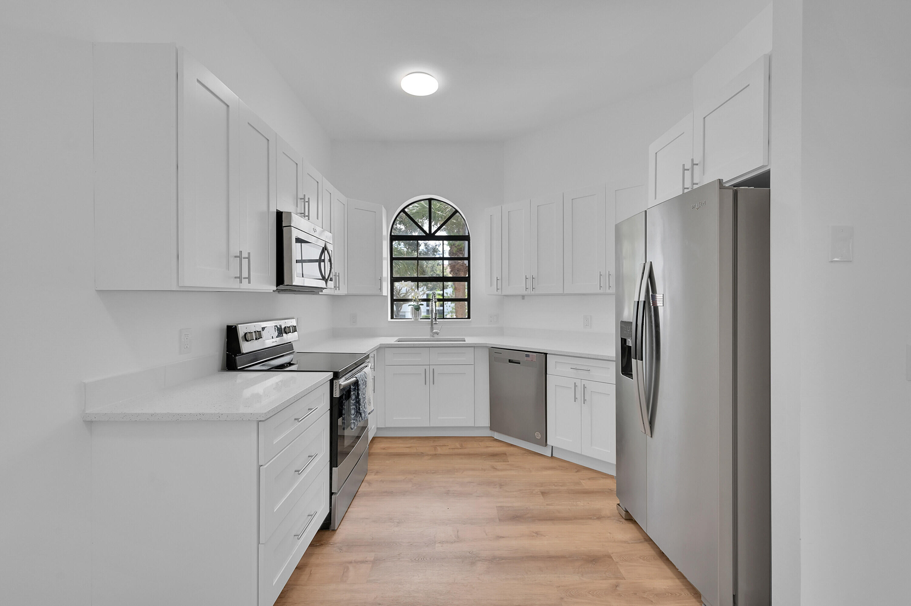 a kitchen with stainless steel appliances granite countertop a refrigerator and a sink