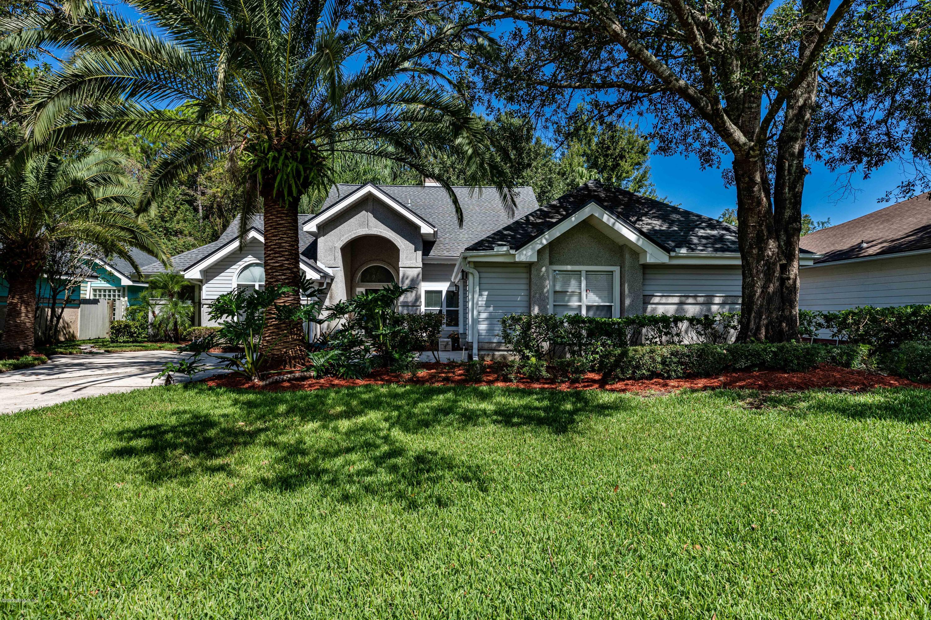 a front view of a house with a yard and porch