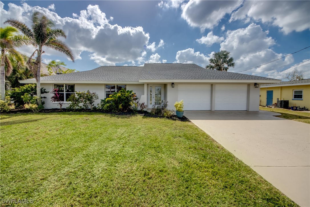 a front view of house with yard and green space