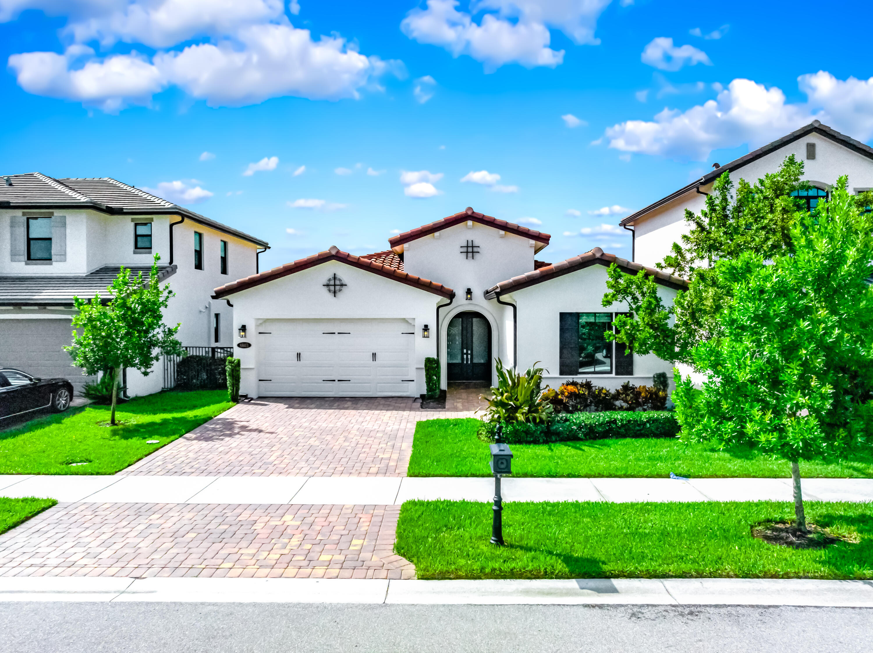 a front view of a house with a yard and garage