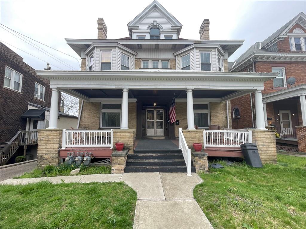 a front view of a house with garden and porch