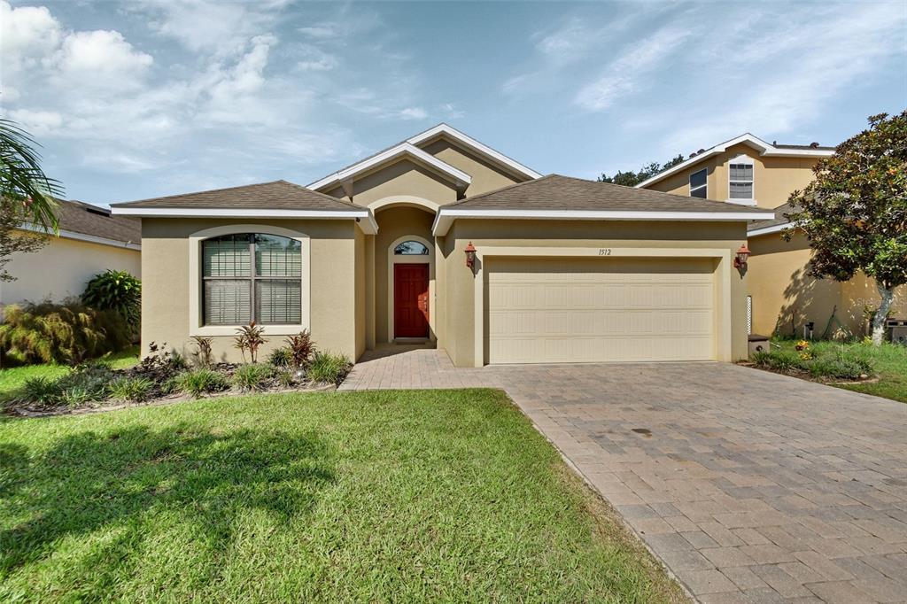 a front view of a house with a yard and garage