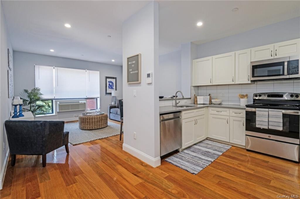 a kitchen with wooden floors and white appliances