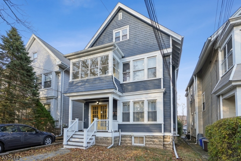 a front view of a house with outdoor seating