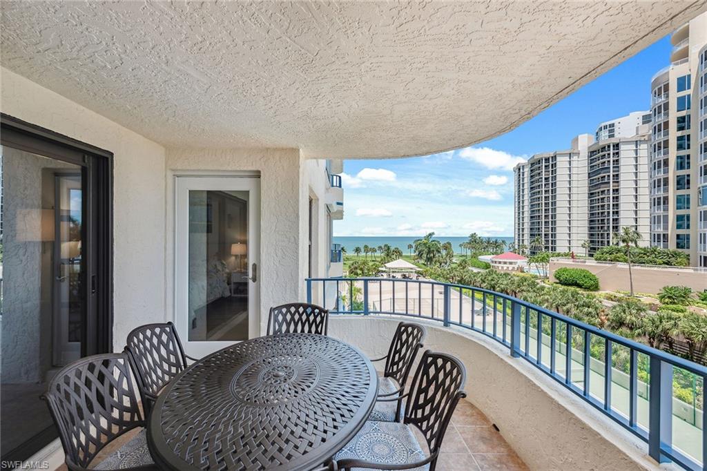 a balcony view with a couch and wooden floor